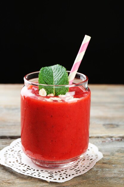 Strawberry smoothie on wooden table background