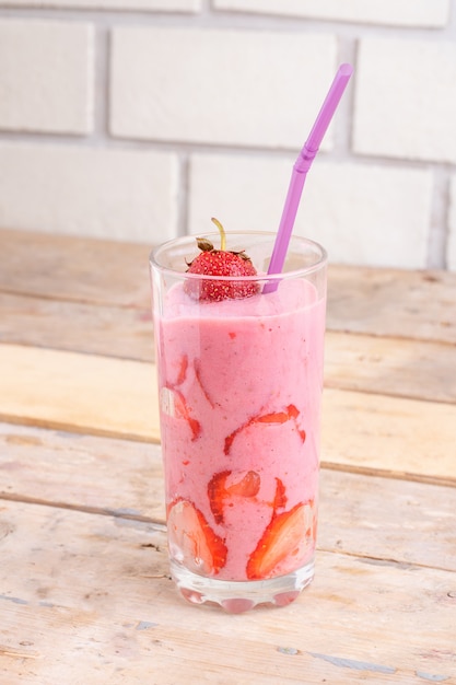 strawberry smoothie on wooden table