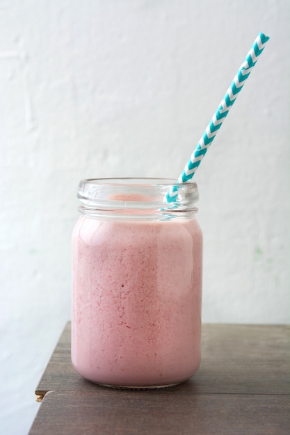 Strawberry smoothie on wooden table