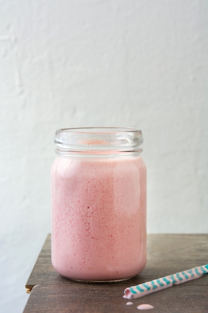 Strawberry smoothie on wooden table