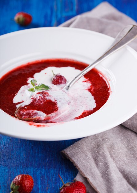 Strawberry soup with ice cream.