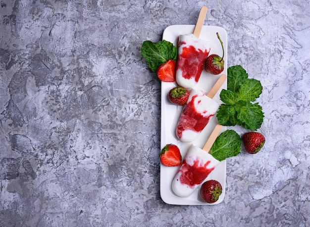 Strawberry vanilla popsicles. Homemade ice cream. Selective focus