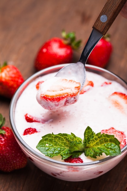 Strawberry yoghurt in a bowl on the table