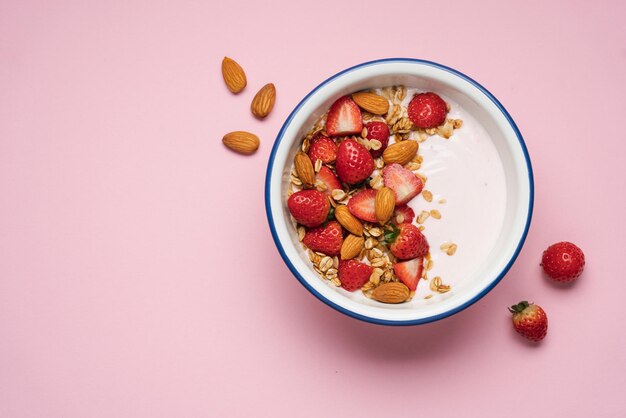 Strawberry yogurt with fresh berries homemade granola almonds in bowl