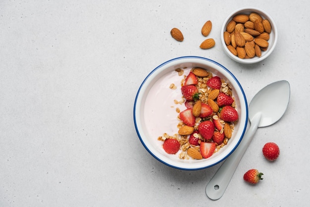 Strawberry yogurt with fresh berries homemade granola almonds in bowl