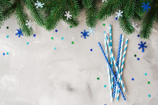 Straws in blue color with Christmas decoration and white background