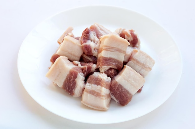 Streaky pork in white plate on white background