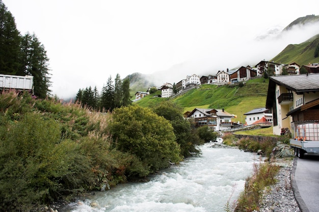 Stream and Glacier from Alps highest and most extensive mountain range flowing passed at Villages of Tschlin and Ramosch near Samnaun a high Alpine village at Graubunden region of Switzerland