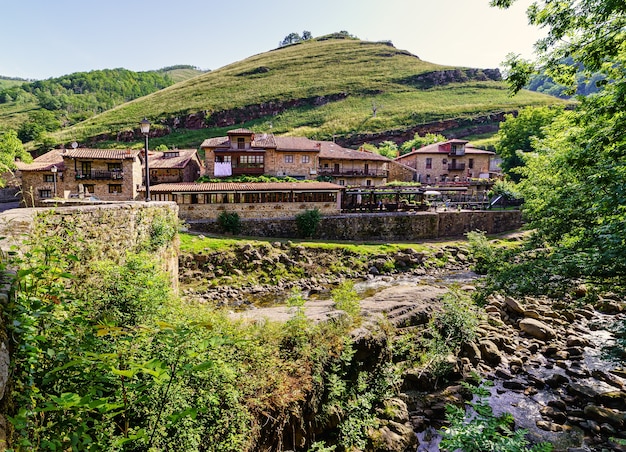 Stream passing next to an old mountain town