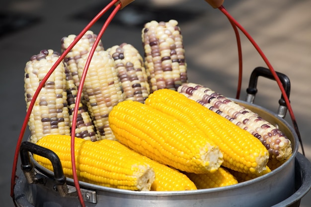 Streaming of corn in pot at outdoor marketplace Thailand