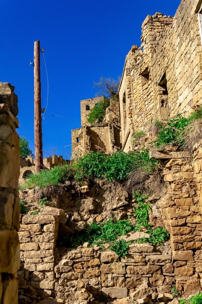 Street in the abandoned village of Gamsutl with ruins of households