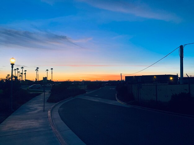 Street against sky at sunset