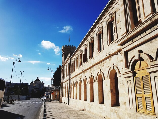 Street amidst buildings in city against sky