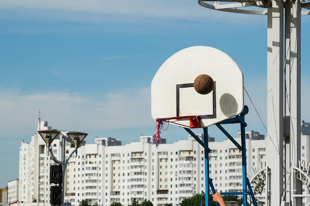 Street basketball court ring board against the sky