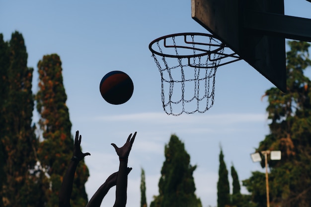 Street basketball game. shield, ball flies to the basket.
accurate throw in basketball ring. concept of sport.