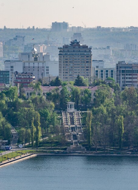 Street by buildings in city against sky