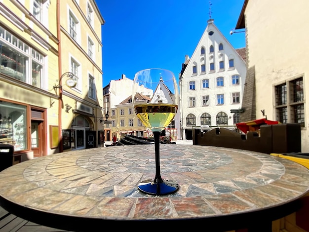 street cafe glass of wine and cup of coffee on table in Tallinn old town