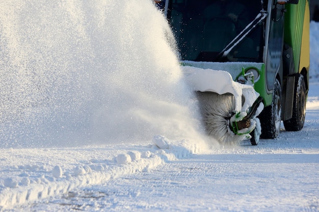 Street cleaning the city from snow with the help of special machinery