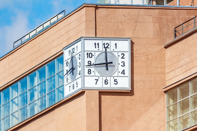 Street clock on building facade