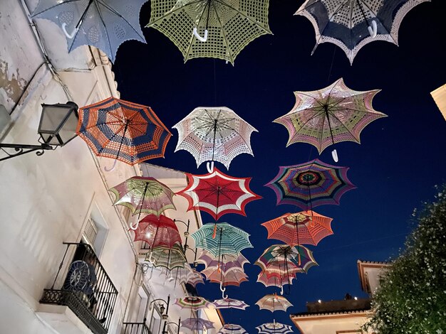 Street decorated with umbrellas during the Luna Mora festival that is celebrated in the town of Guar