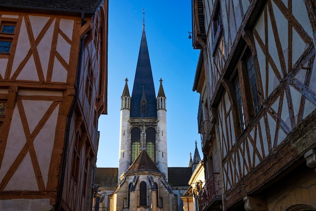 Street of Dijon with traditional houses and bell tower