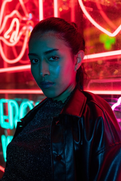 Street fashion young girl, neon light red blue, nightlife and trendy lifestyle