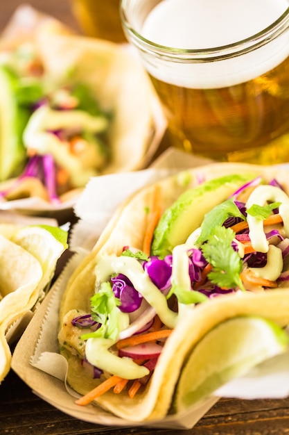 Street fish tacos with cod in recycled paper food tray.