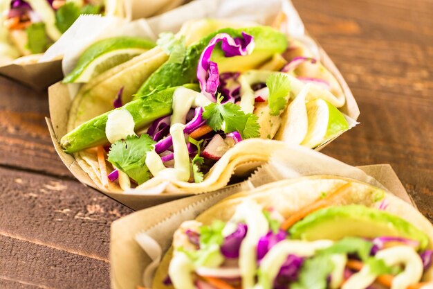 Street fish tacos with cod in recycled paper food tray.