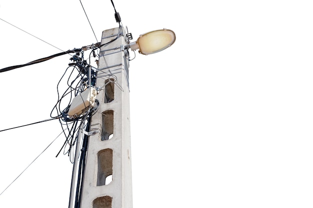 Street flood light post with a lot of wires against white sky background