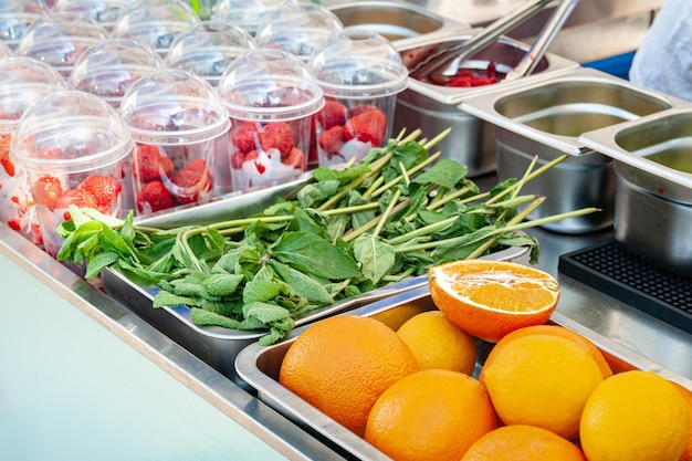 Street food Fruits and berries for fresh Oranges lemons mint and strawberries for making juice