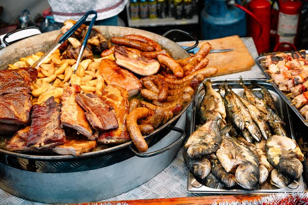Premium Photo | Street food meats and fish on display