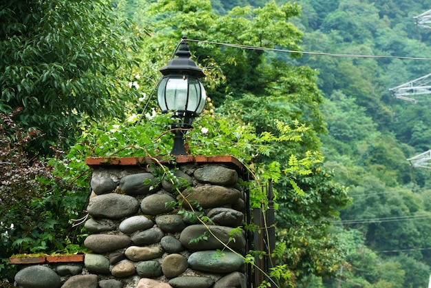 Street lamp on a stone fence