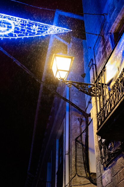 A street lamp with its light on a rainy night We are in the town of Olite Navarra Spain