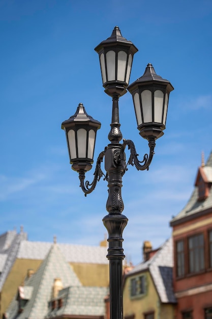 Street lamppost against the old buildings background Classic victorian street lamps on an old fashioned iron lamp post set