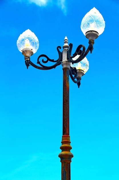 Street light against blue sky