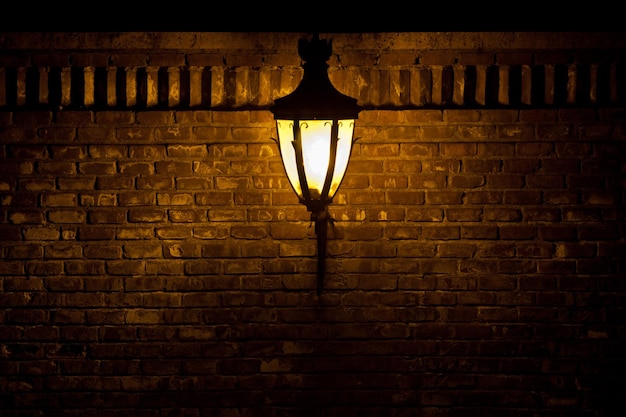 Street light against brick wall