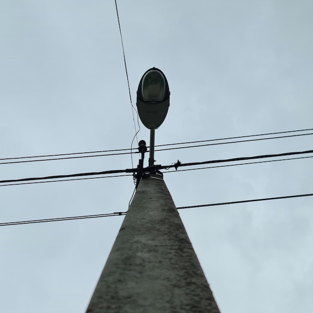 A street light with a blue sky in the background