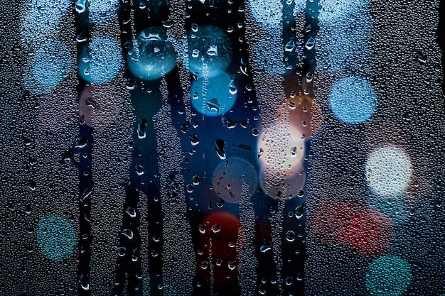 street lights and raindrops on the window at night