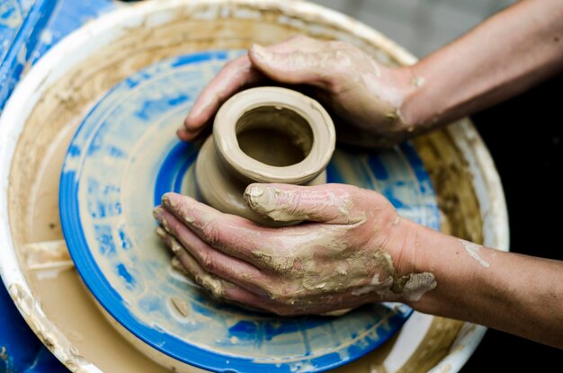 Street master class on modeling of clay on a potter's wheel In the pottery workshop