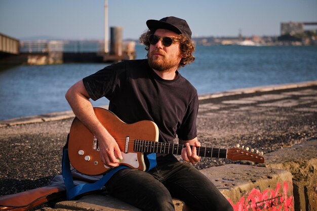 Street musician playing electric guitar in the street