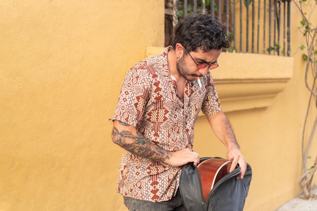 Street musician preparing the guitar