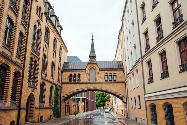 Street of the old city after the rain with beautiful yellow buildings and a road wet from water.