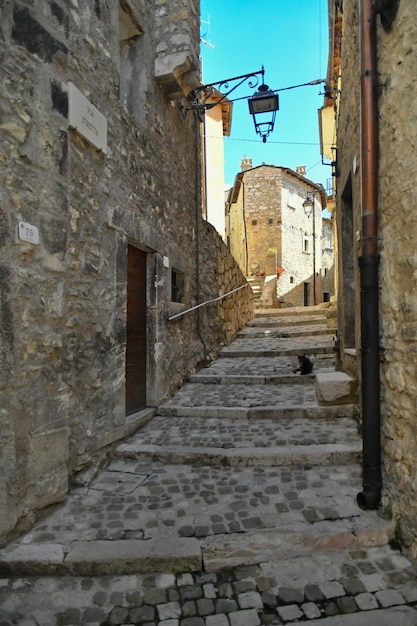 A street between the old stone houses of Barrea a medieval village in the Abruzzo region of Italy