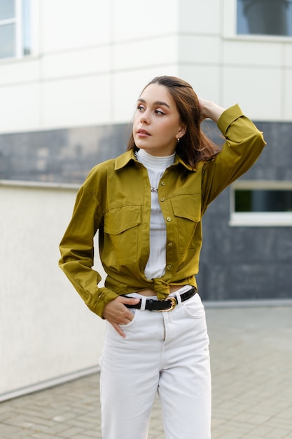 Street photo. young slim fashion model posing outdoors