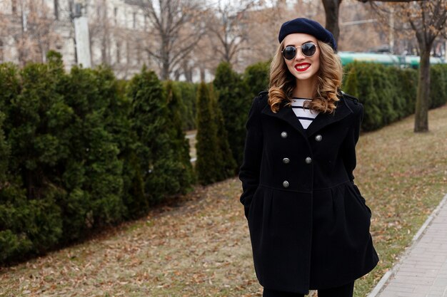 Street photo of young woman wearing stylish classic clothes