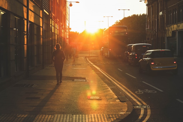 Street scene of people walking during the sunset on Oxford street