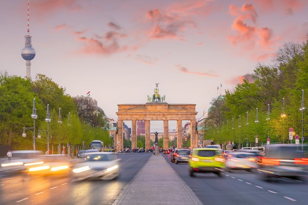 A street scene with a view of the brandenburg gate in the background.