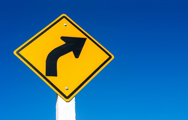 Street sign against blue sky