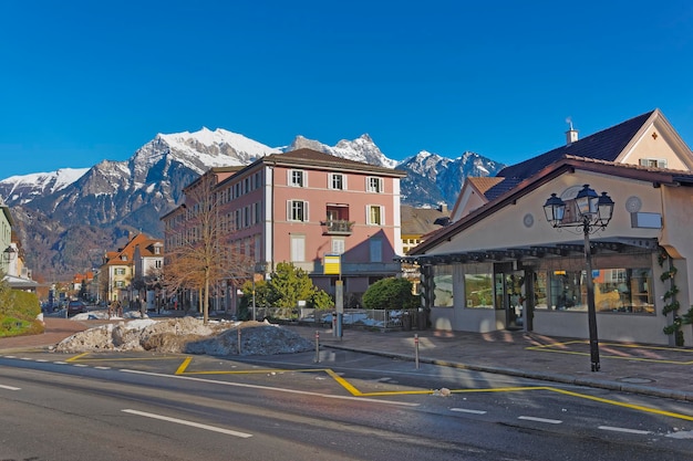 Street view and the Alps in the Town of Bad Ragaz. Bad Ragaz is a city in canton St. Gallen in Switzerland.  It lies over Graubunden Alps. Spa and recreation village is at end of Tamina valley