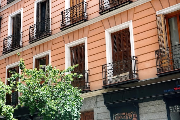 Street view looking up at apartment block in city Madrid. Traditional architecture of Madrid, Spain